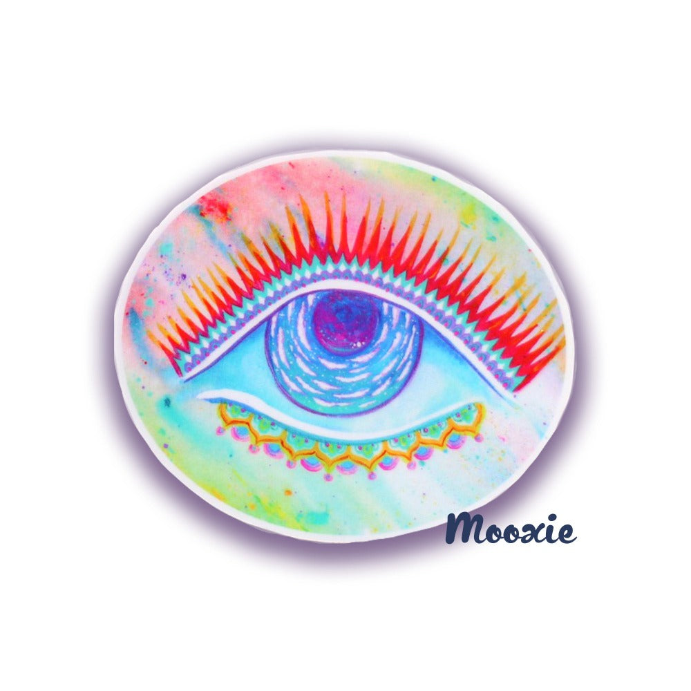 Oval vinyl sticker art mockup featuring a single galactic eye centered on a rainbow gradient background. Inside the eye sits a dark moon circled by clouds representing a cosmic guardian. Divine feminine channeled art.